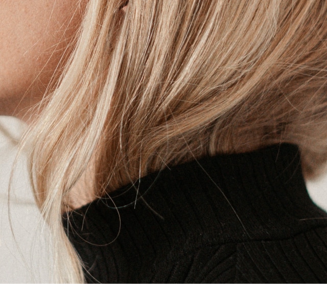 Cheveux blonds dans col roulé noir